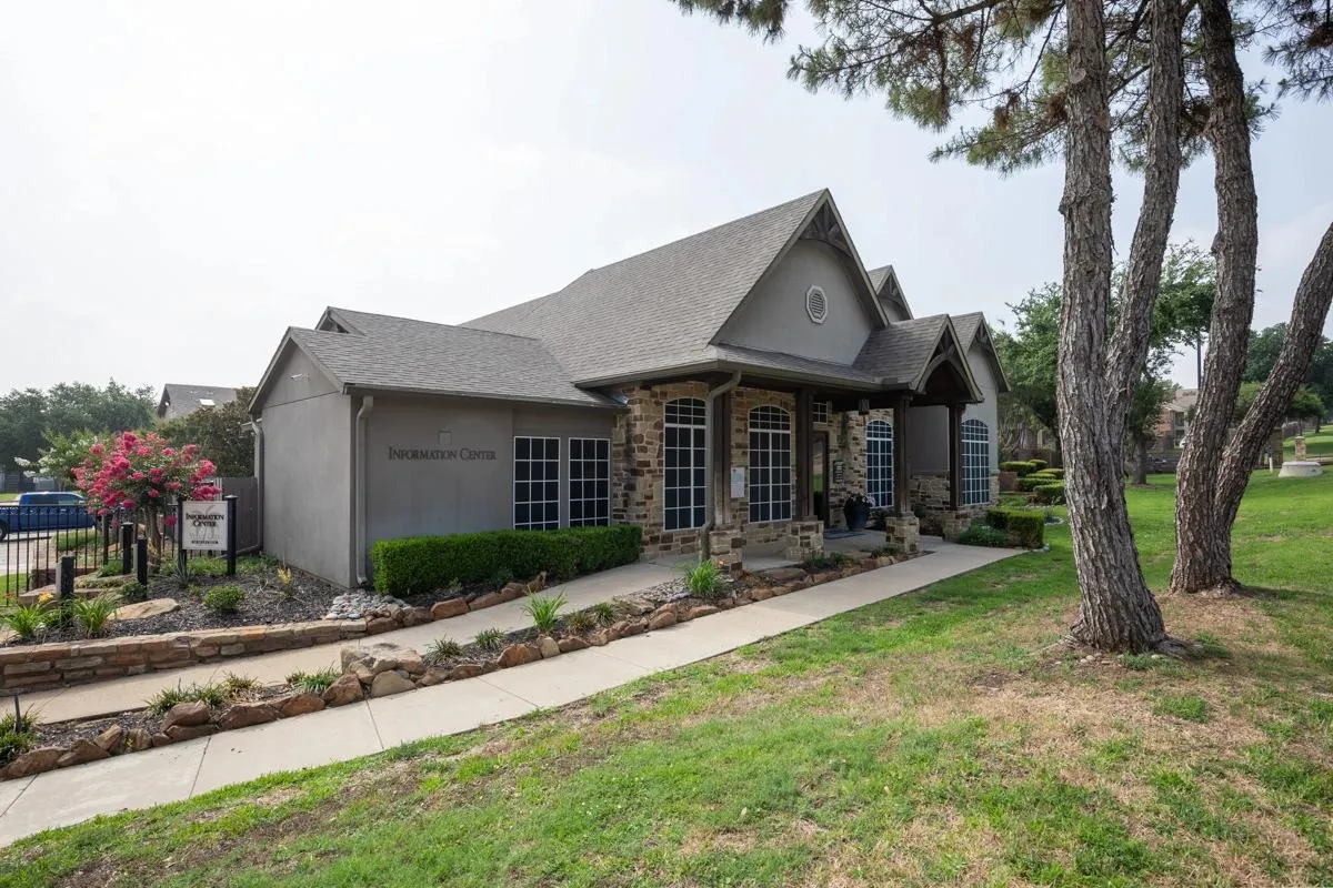 Leasing office and clubhouse entrance walkway at Village Green of Bear Creek in Euless, Texas