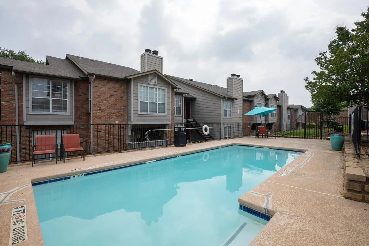 Community pool and residential buildings at Village Green of Bear Creek in Euless, Texas