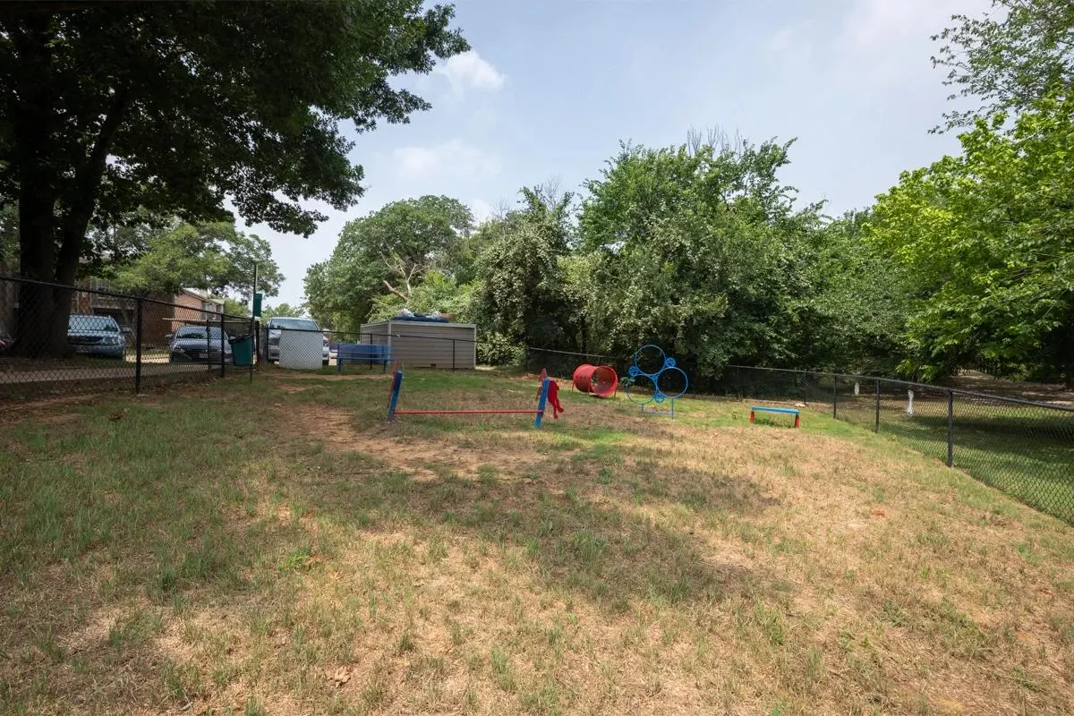 Fenced bark park green space at Village Green of Bear Creek in Euless, Texas