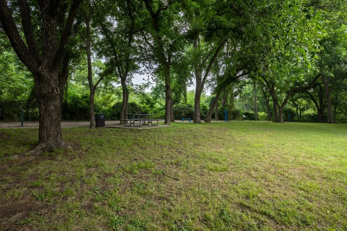 Shaded picnic grounds at Village Green of Bear Creek in Euless, Texas
