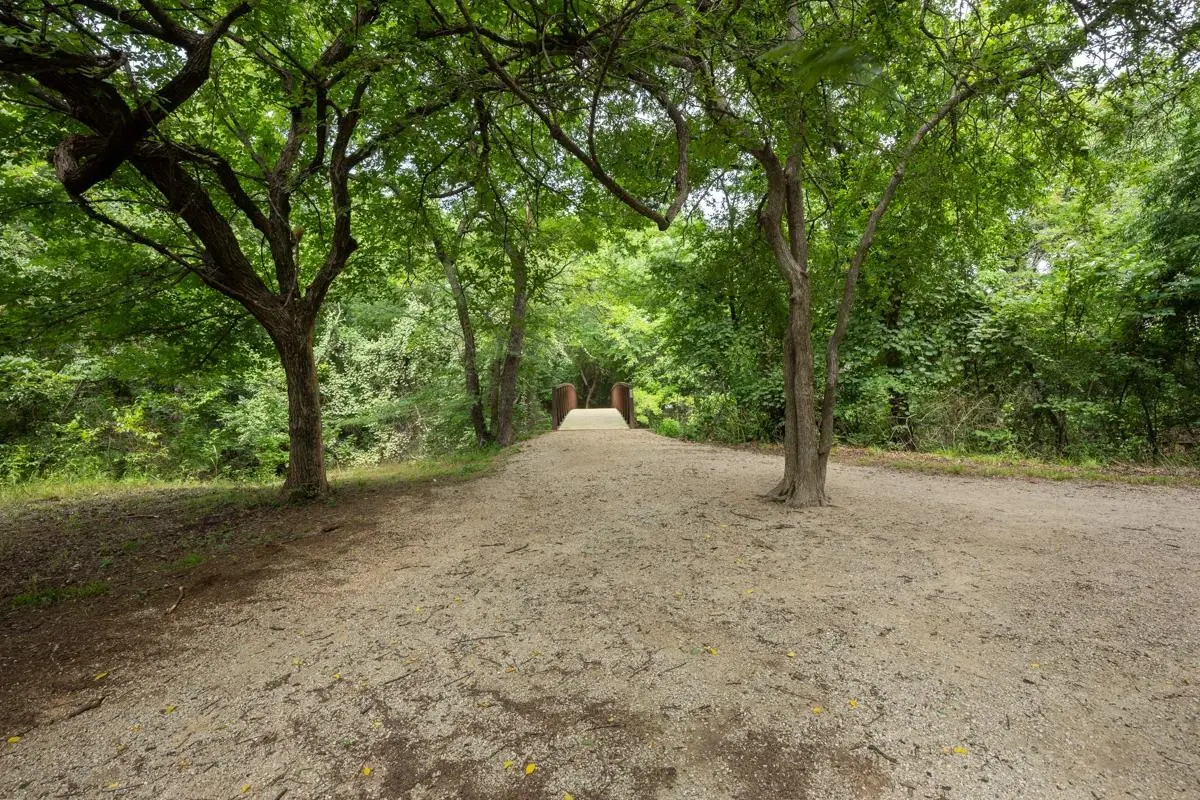 Wooded walking trails and path at Village Green of Bear Creek in Euless, Texas