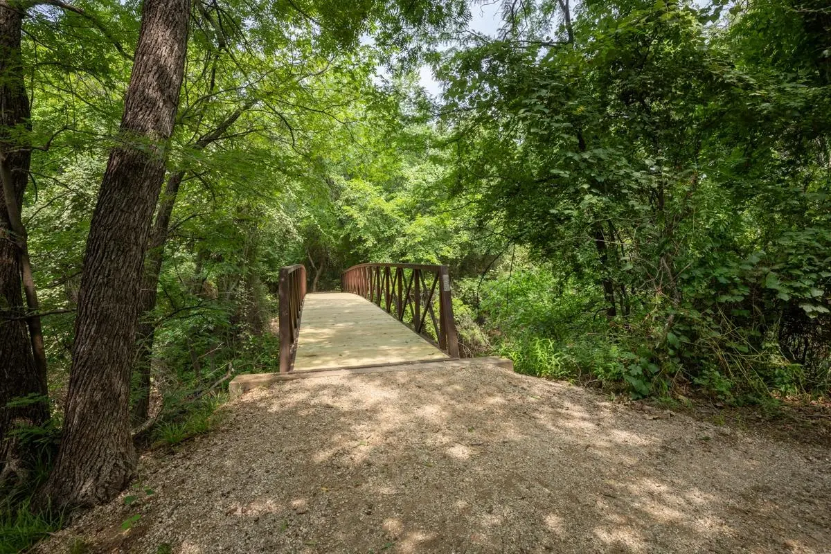 Scenic trail footbridge at Village Green of Bear Creek in Euless, Texas