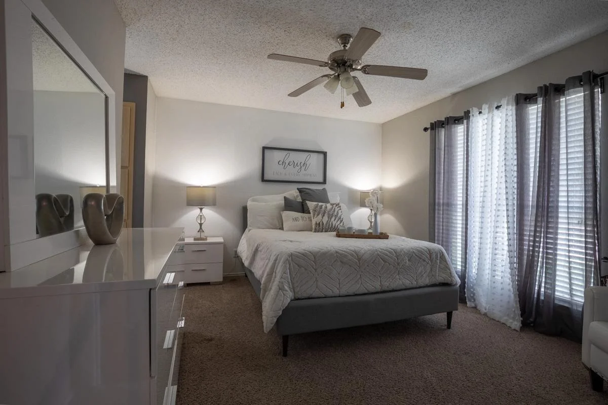 Primary bedroom suite with dresser at Village Green of Bear Creek in Euless, Texas