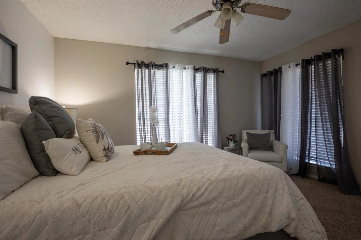 Primary bedroom with natural light at Village Green of Bear Creek in Euless, Texas