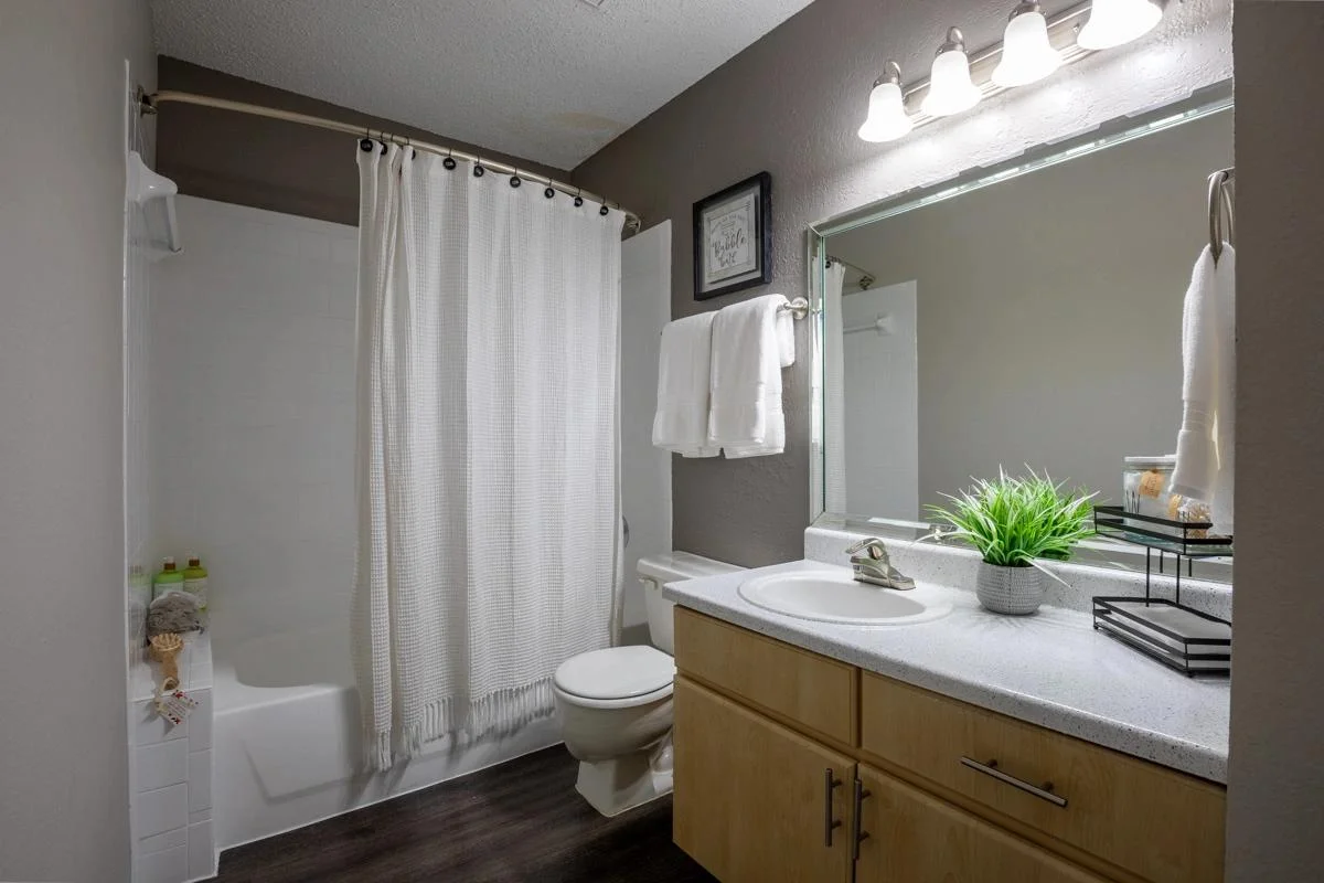 Full bathroom with large vanity and tub at Village Green of Bear Creek in Euless, Texas