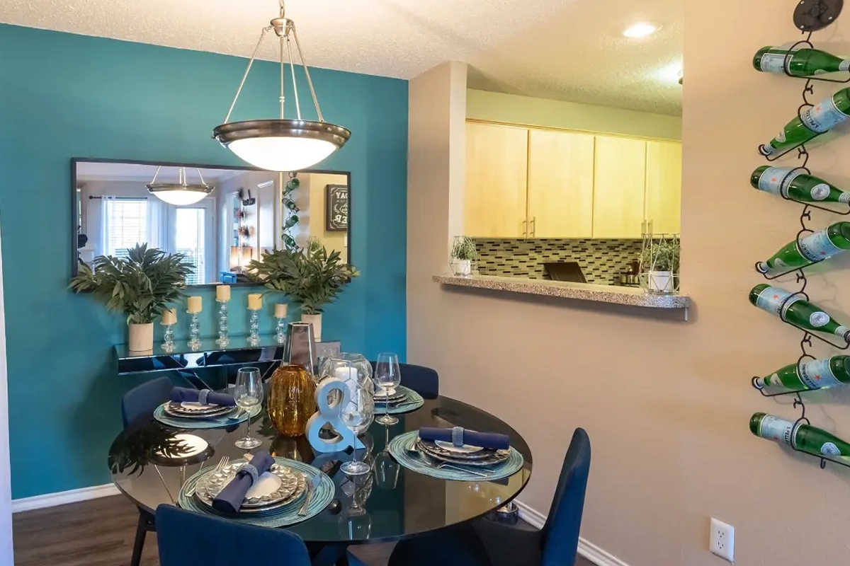 Dining area and pass-through bar inside an apartment at Village Green of Bear Creek in Euless, Texas